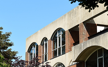 A close-up of one of the campus buildings showing its distinctive arched windows